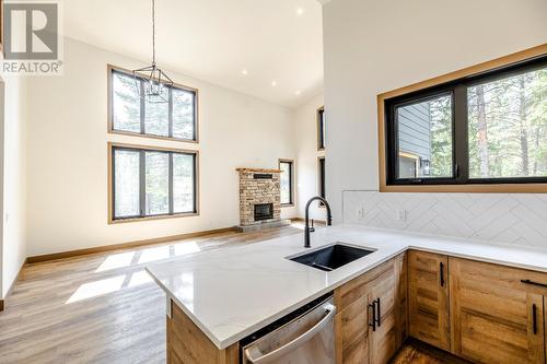 6674 Wardner-Kikomun Road Unit# 10, Wardner, BC - Indoor Photo Showing Kitchen With Fireplace With Double Sink