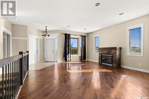 15 Stardust Bay, White City, SK - Indoor Photo Showing Living Room With Fireplace