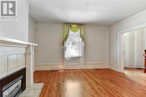 Living Room with hardwood floors - 22 James Street E, Brockville, ON - Indoor Photo Showing Other Room With Fireplace