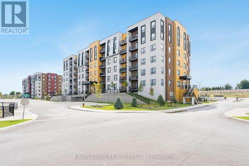 211 - 8 Culinary Lane, Barrie (Innis-Shore), ON - Outdoor With Balcony With Facade