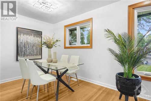 Elegant dining room with modern lighting, perfect for gatherings. - 1155 Minnetonka Road, Ottawa, ON - Indoor Photo Showing Dining Room