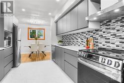 Sleek, modern kitchen with brand-new appliances and soft-close cabinets. - 