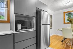 Sleek, modern kitchen with brand-new appliances and soft-close cabinets. - 