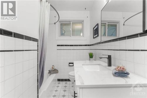 Stylish main floor bathroom with modern fixtures and timeless design - 1155 Minnetonka Road, Ottawa, ON - Indoor Photo Showing Bathroom