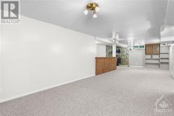 Spacious basement recreation room, perfect for relaxation and entertainment. - 