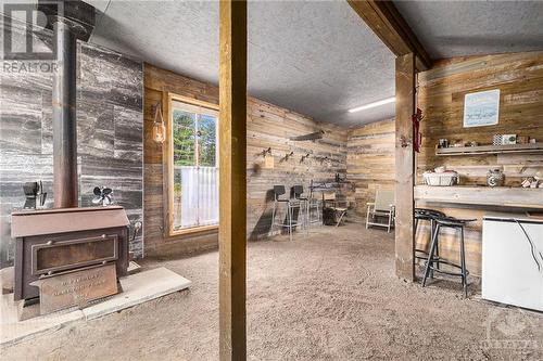 Wood Stove & Bar in Barn - 5055 Loggers Way, Ottawa, ON - Indoor Photo Showing Other Room