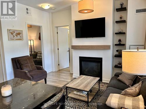 307 - 40 Horseshoe Boulevard, Oro-Medonte, ON - Indoor Photo Showing Living Room With Fireplace