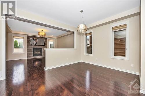 Dining Room looking into Living Room with fireplace. - 231 Des Soldats-Riendeau Street, Ottawa, ON - Indoor With Fireplace