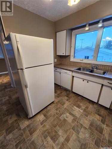 205 1St Avenue Nw, Weyburn, SK - Indoor Photo Showing Kitchen With Double Sink