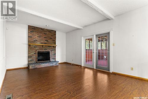 6 Wood Crescent, Regina, SK - Indoor Photo Showing Living Room With Fireplace