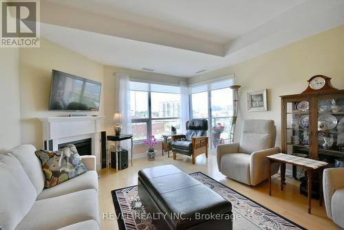 709 - 6 Toronto Street, Barrie, ON - Indoor Photo Showing Living Room With Fireplace