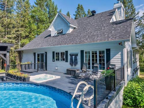 Face arriÃ¨re - 110 7E Rang, Mont-Tremblant, QC - Outdoor With Above Ground Pool With Deck Patio Veranda