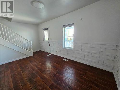 This is the living room of the vacant unit. Notice the newly added woodwork on the walls creating a modern, architectural vibe. There is new flooring installed throughtout. - 307-309 Prince Arthur Street, Cornwall, ON - Indoor Photo Showing Other Room