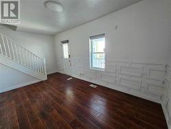 This is the living room of the vacant unit. Notice the newly added woodwork on the walls creating a modern, architectural vibe. There is new flooring installed throughtout. - 