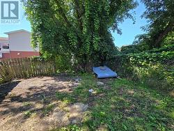 There is parking space in the back for two cars as well as driveway parking. This photo shows the vacant side. There is a more space behind the tenanted side which is currently used as  garden. - 