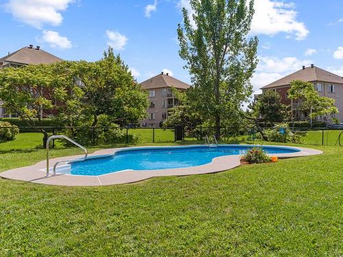 Pool - 1-7490 Rue Lautrec, Brossard, QC - Outdoor With In Ground Pool With Backyard