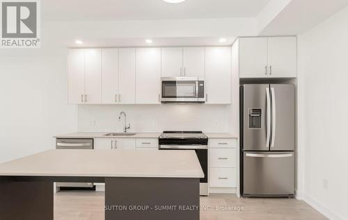 1117 - 3220 William Coltson Avenue, Oakville, ON - Indoor Photo Showing Kitchen With Stainless Steel Kitchen