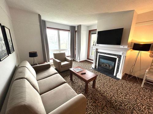 Living room - 427D-150 Ch. Au Pied-De-La-Montagne, Mont-Tremblant, QC - Indoor Photo Showing Living Room With Fireplace