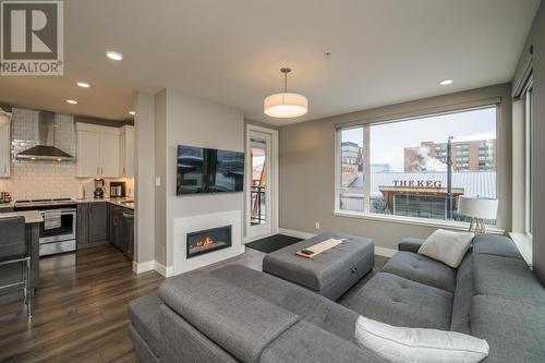 201 1087 6Th Avenue, Prince George, BC - Indoor Photo Showing Living Room With Fireplace