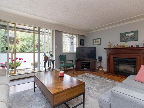 214-1025 Inverness Rd, Saanich, BC - Indoor Photo Showing Living Room With Fireplace