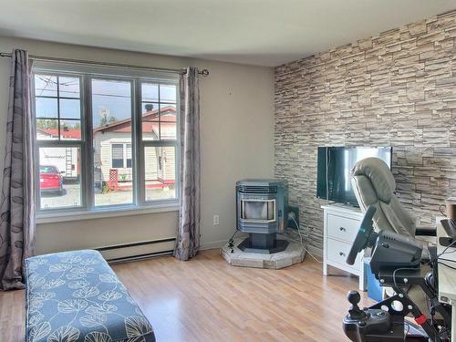 Salon - 21 Rue Yvon, Rouyn-Noranda, QC - Indoor Photo Showing Bedroom With Fireplace