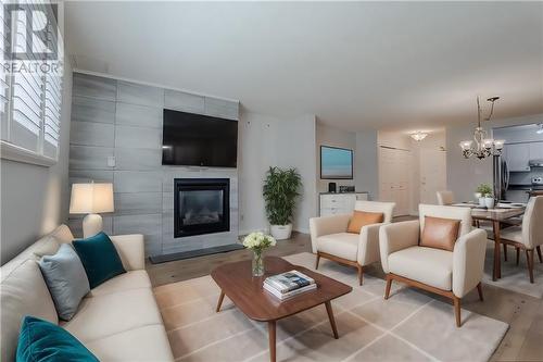 This photo has been virtually staged. - 121 Water Street W Unit#112, Cornwall, ON - Indoor Photo Showing Living Room With Fireplace