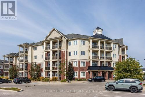 229 - 80 Aspen Springs Drive, Clarington (Bowmanville), ON - Outdoor With Balcony With Facade