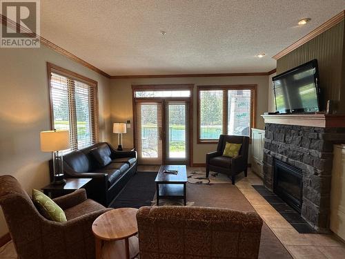 200 Bighorn  Boulevard Unit# 211D, Radium Hot Springs, BC - Indoor Photo Showing Living Room With Fireplace