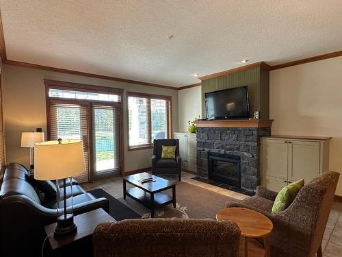 211D - 200 Bighorn Boulevard, Radium Hot Springs, BC - Indoor Photo Showing Living Room With Fireplace