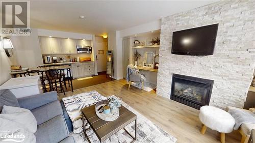 1235 Deerhurst Drive Unit# 52-308, Huntsville, ON - Indoor Photo Showing Living Room With Fireplace