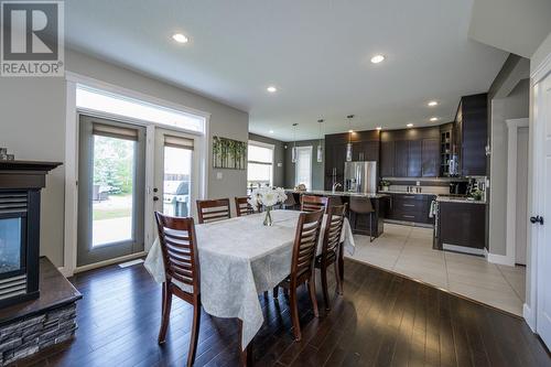 6957 Westmount Drive, Prince George, BC - Indoor Photo Showing Dining Room With Fireplace