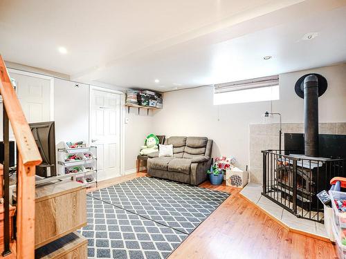 Family room - 1063 Rue Simonet, Laval (Saint-François), QC - Indoor Photo Showing Basement With Fireplace