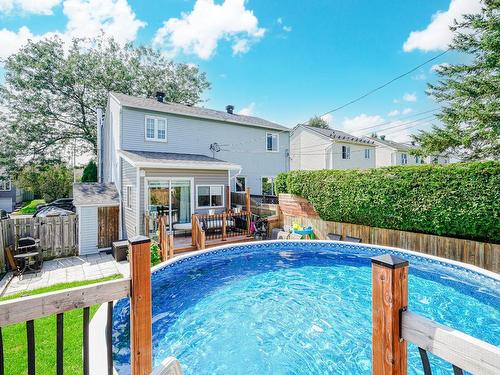 Back facade - 1063 Rue Simonet, Laval (Saint-François), QC - Outdoor With Above Ground Pool With Deck Patio Veranda