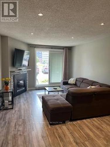 Living Area with Gas Fireplace - 103 - 1096 Jalna Boulevard, London, ON - Indoor Photo Showing Living Room With Fireplace