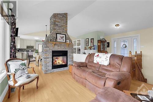 Cozy double sided fireplace. - 3695 Front Road, Hawkesbury, ON - Indoor Photo Showing Living Room With Fireplace