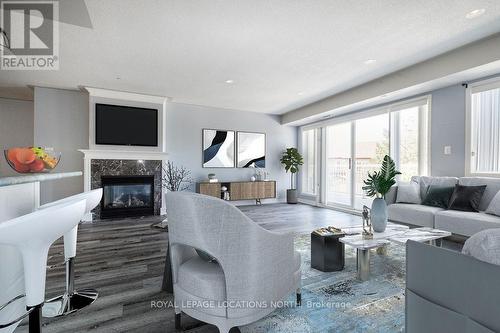 205 - 4 Beck Boulevard, Penetanguishene, ON - Indoor Photo Showing Living Room With Fireplace