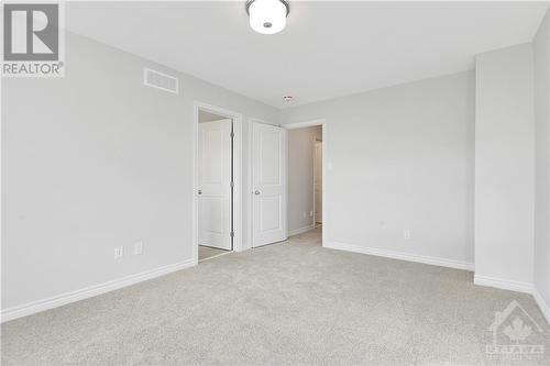 Primary bedroom to ensuite and door - 343 Kanashtage Terrace, Ottawa, ON - Indoor Photo Showing Other Room