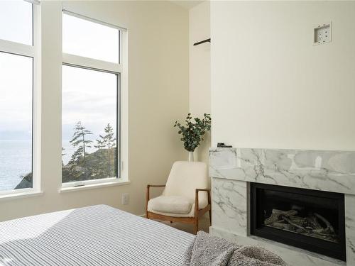7510 Ocean Park Pl, Sooke, BC - Indoor Photo Showing Bedroom With Fireplace