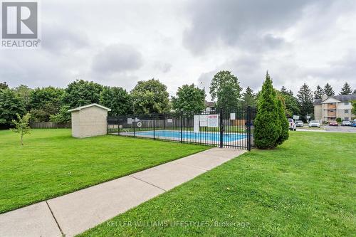 View of pool from parking lot in front of unit - 103 - 729 Deveron Crescent, London, ON - Outdoor With In Ground Pool