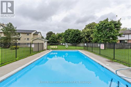 Communal pool is a short walk across the lawn - 103 - 729 Deveron Crescent, London, ON - Outdoor With In Ground Pool With Backyard