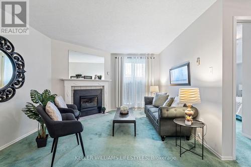 Keyed entry through patio doors - 103 - 729 Deveron Crescent, London, ON - Indoor Photo Showing Living Room With Fireplace