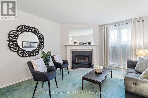 Living room with gas fireplace - 103 - 729 Deveron Crescent, London, ON - Indoor Photo Showing Living Room With Fireplace