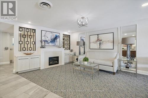 702 - 1230 Marlborough Court, Oakville (College Park), ON - Indoor Photo Showing Living Room With Fireplace