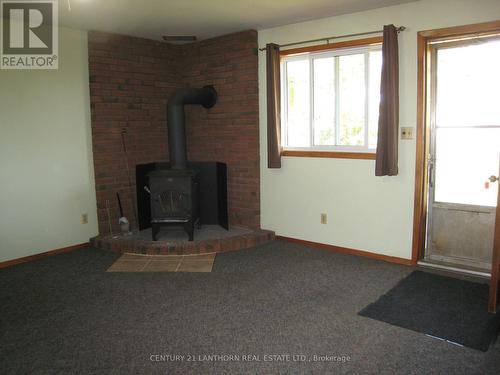 1194 County Rd 1, Prince Edward County (Bloomfield), ON - Indoor Photo Showing Other Room With Fireplace