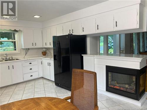 27 Hill Street, St. Stephen, NB - Indoor Photo Showing Kitchen With Fireplace With Double Sink