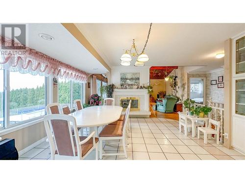 1225 Mountain Avenue, Kelowna, BC - Indoor Photo Showing Dining Room With Fireplace