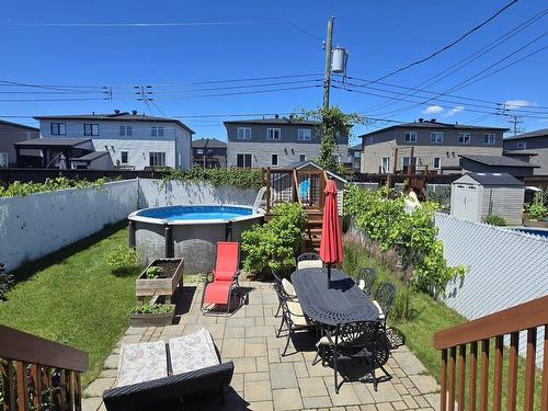 Backyard - 7395 Rue Lachance, Laval (Duvernay), QC - Outdoor With Above Ground Pool