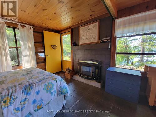 890 Mazinaw Lake, Addington Highlands, ON - Indoor Photo Showing Bedroom With Fireplace