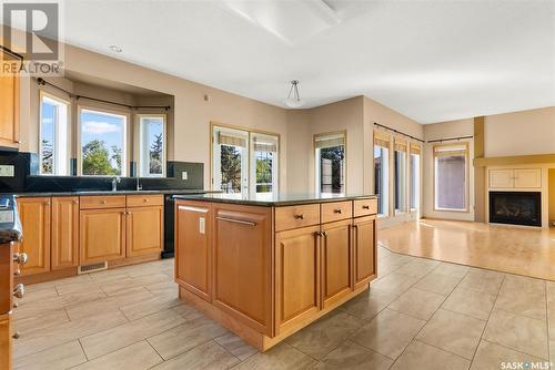 6006 Wascana Court, Regina, SK - Indoor Photo Showing Kitchen With Fireplace