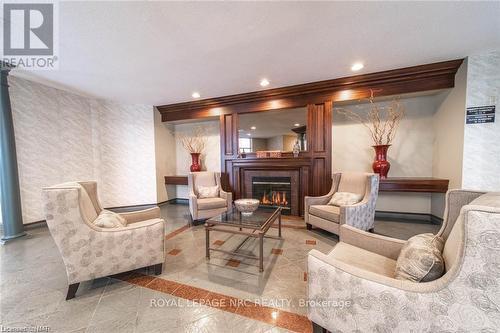 209 - 8111 Forest Glen Drive, Niagara Falls, ON - Indoor Photo Showing Living Room With Fireplace